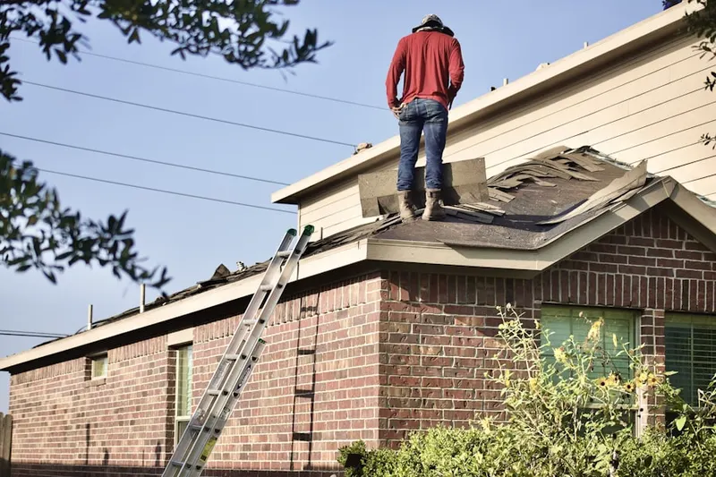 Professional roofer working on a residential roof in Hunter Estates
